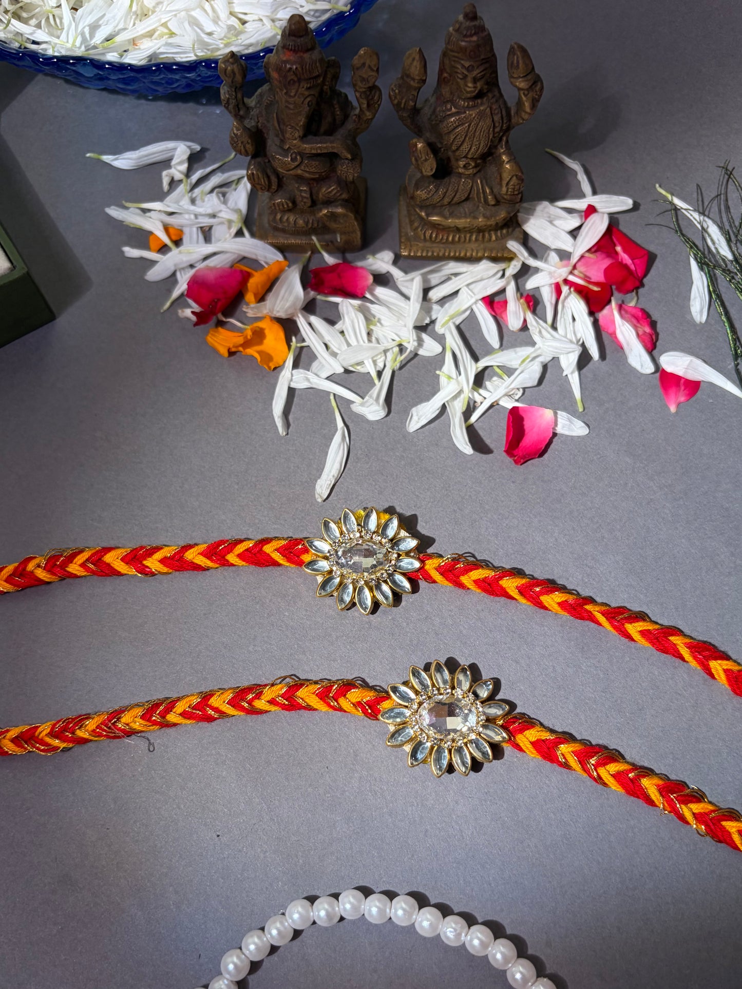 Floral Stone Rakhi with Red & Yellow Thread